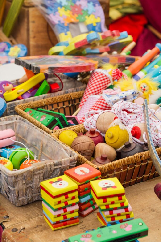 A pile of kids toys on a floor.