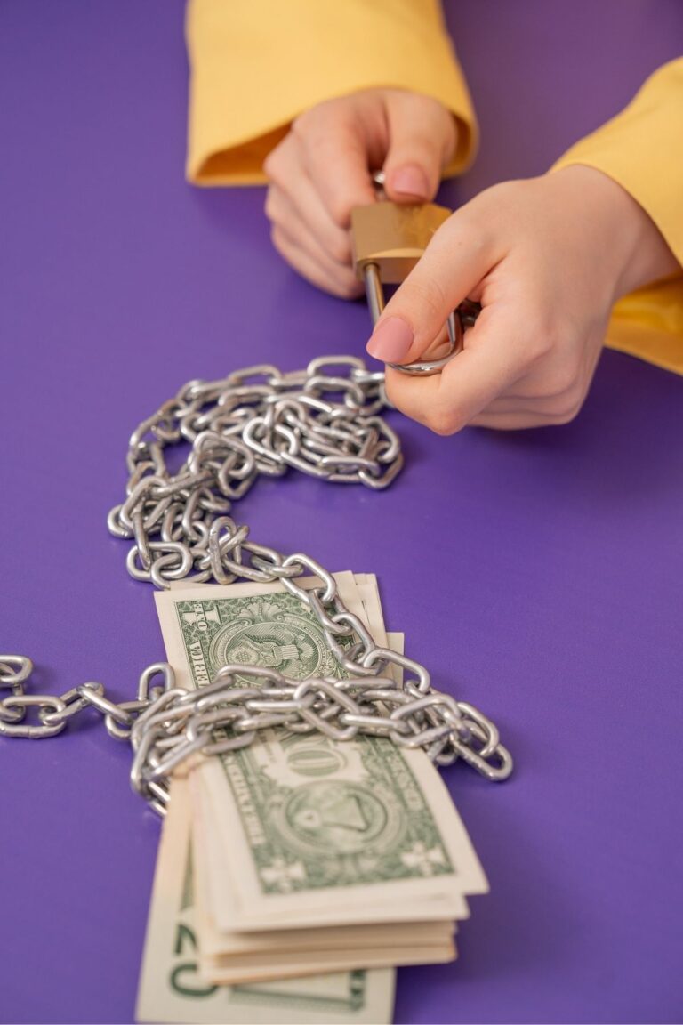 dollar bills wrapped in chains to show debt.